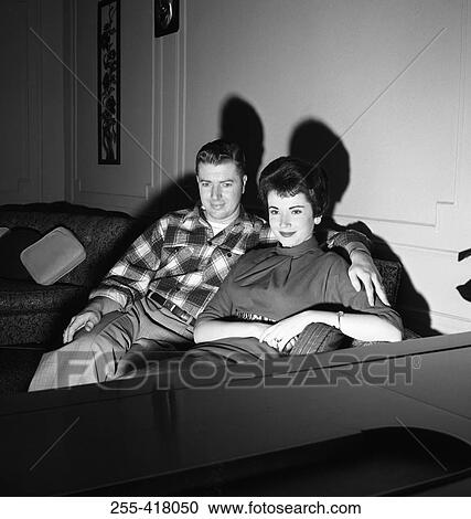 Stock Image - Young couple watching television. Fotosearch