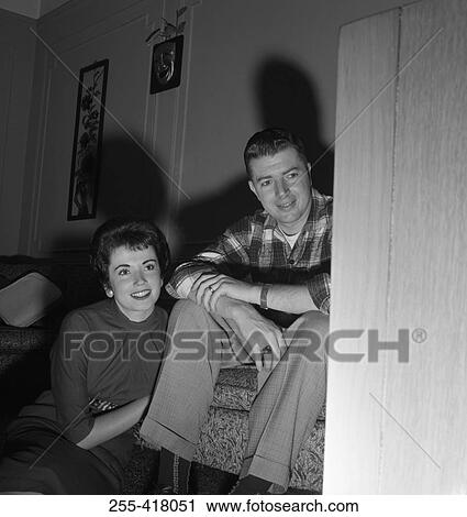 Young couple watching television View Large Photo Image Stock Image - Young couple watching television. Fotosearch