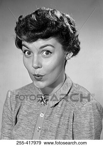 Stock Photo - Young female flight attendant standing in aiplane door and smiling. Fotosearch