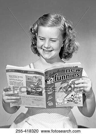 Stock Image - Young girl reading magazine. Fotosearch