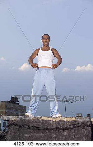 Young man clenching fists on a rooftop, New York City, New York State, USA View Large Photo Image Stock Image - Young man clenching fists on a rooftop, New York City, New York State, USA. Fotosearch