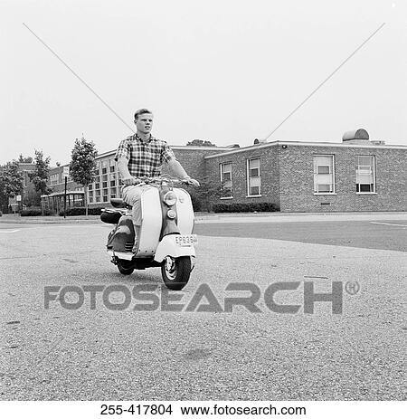 Picture - Young man driving scooter. Fotosearch