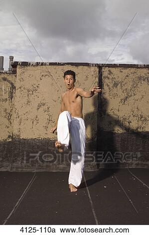Young man practicing martial arts, New York City, New York State, USA View Large Photo Image Stock Image - Young man practicing martial arts, New York City, New York State, USA. Fotosearch