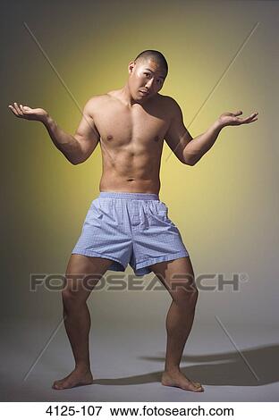 Stock Photo - Young man shrugging. Fotosearch
