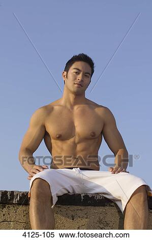 Young man sitting on the rooftop, New York City, New York State, USA View Large Photo Image Stock Photography - Young man sitting on the rooftop, New York City, New York State, USA. Fotosearch