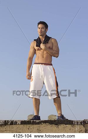 Young man standing on the rooftop, New York City, New York State, USA View Large Photo Image Picture - Young man standing on the rooftop, New York City, New York State, USA. Fotosearch