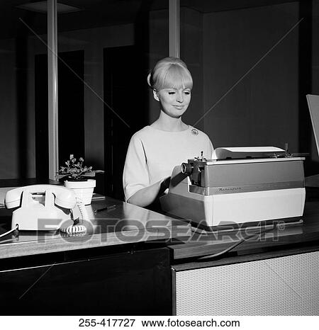 Stock Photo - Young secretary working on typing machine. Fotosearch