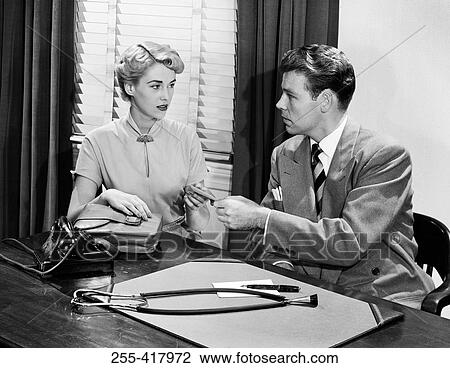 Young woman and young man at doctor's office View Large Photo Image Stock Image - Young woman and young man at doctor's office. Fotosearch