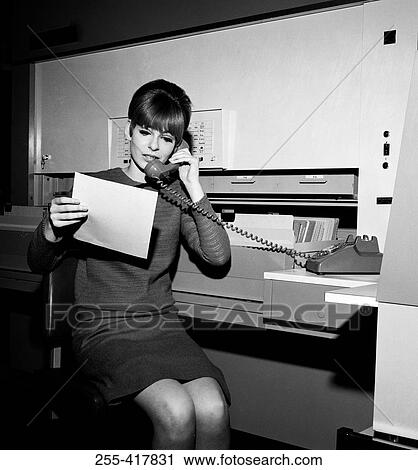 Young woman at office on the phone View Large Photo Image Stock Image - Young woman at office on the phone. Fotosearch