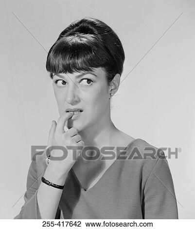 Young woman biting nails View Large Photo Image Stock Image - Young woman biting nails. Fotosearch