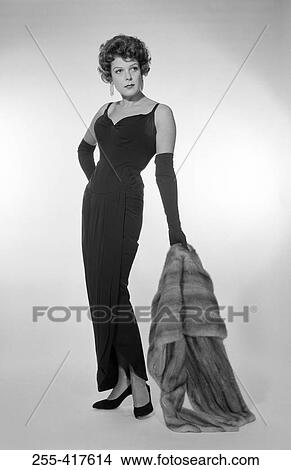 Young woman holding fur coat View Large Photo Image Picture - Young woman holding fur coat. Fotosearch