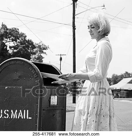 Young woman putting letters in US Mail letter box View Large Photo Image Stock Image - Young woman putting letters in US Mail letter box. Fotosearch