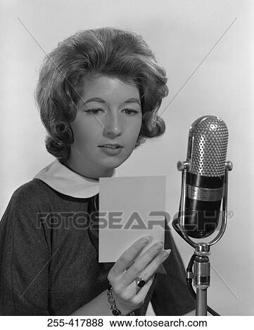 Stock Photo - Young woman reading into microphone. Fotosearch