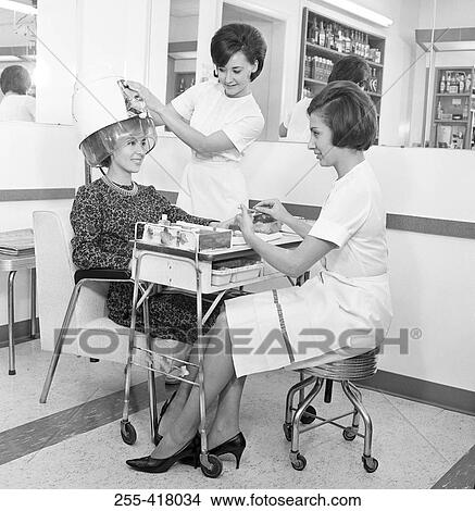 Young woman receiving manicure in hair salon View Large Photo Image Picture - Young woman receiving manicure in hair salon. Fotosearch