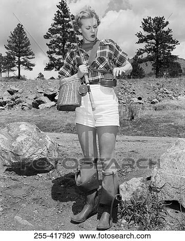 Young woman searching for bait in can to put on hook View Large Photo Image Stock Photo - Young woman searching for bait in can to put on hook. Fotosearch