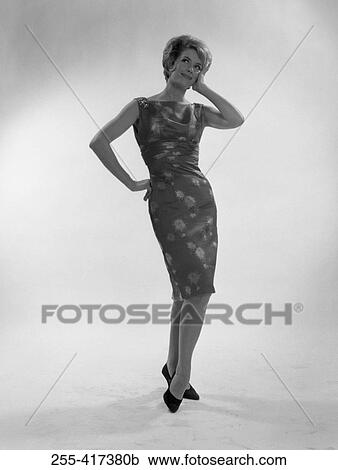 Young woman smiling and looking up, studio shot View Large Photo Image Stock Image - Young woman smiling and looking up, studio shot. Fotosearch