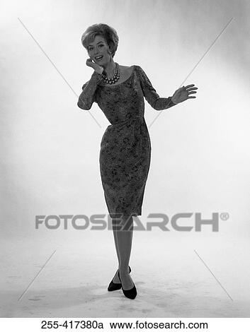 Young woman smiling and posing, studio shot View Large Photo Image Stock Image - Young woman smiling and posing, studio shot. Fotosearch