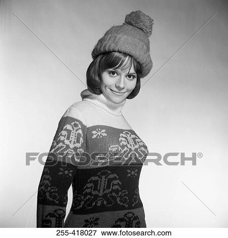 Young woman wearing knit hat and warm sweater smiling View Large Photo Image Stock Photo - Young woman wearing knit hat and warm sweater smiling. Fotosearch