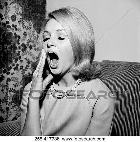 Stock Photograph - Young woman yawning. Fotosearch