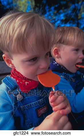 Two Young Boys With Blonde Hair Wearing Overalls And Bandanas