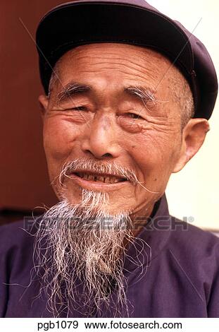Stock Photograph of Old Chinese man with a wispy mandarin beard and