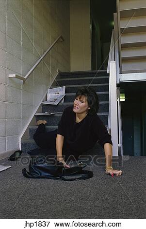 Woman falling down stairs of apartment building Stock Photo | jhp1837