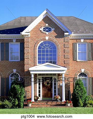 Exterior View Of Front Of Large Two Story Red Brick House With