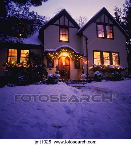 English Tudor Style Home With Snow And Christmas Decorations