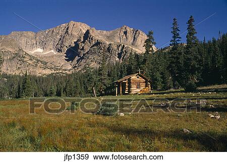 A Rustic Cabin Sits Beneath Mt Alice Near Thunder Lake In Rocky