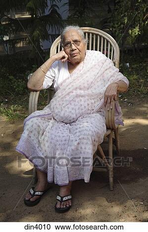 South Asian Indian Old Lady Sitting On Cane Chair India Stock