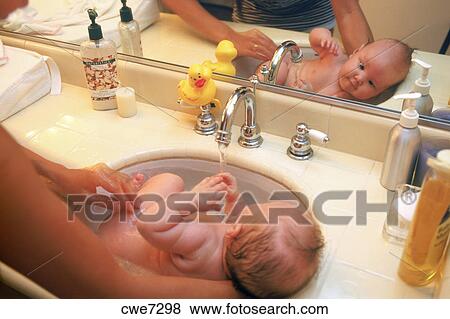 Mom Bathing Baby 3 6 Months Old In Bathroom Sink Stock Photo