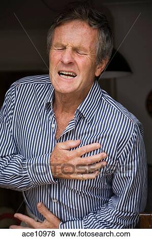 Senior man having a heart attack, clutching his heart Stock Photo ...