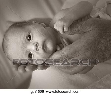 A Tiny Premature Baby Cradled In The Large Hands Of A Male Stock Photograph Gtn1506 Fotosearch