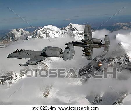 A-10 Thunderbolt II's fly over mountainous landscape. View Large Photo Image Picture - A-10 Thunderbolt II's fly over mountainous landscape.. Fotosearch