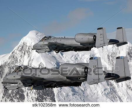A-10 Thunderbolt II's fly over mountainous landscape. View Large Photo Image Picture - A-10 Thunderbolt II's fly over mountainous landscape.. Fotosearch
