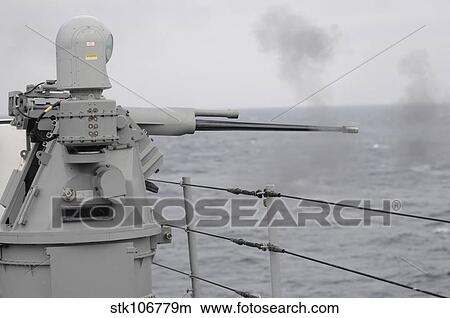 Picture - A 25mm machine gun is fired aboard USS Blue Ridge.. Fotosearch