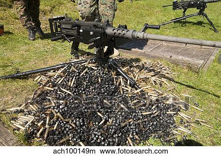 A. 50 Caliber Browning Machine Gun with a pile of spent cases and links. View Large Photo Image Picture - A. 50 Caliber Browning Machine Gun with a pile of spent cases and links.. Fotosearch