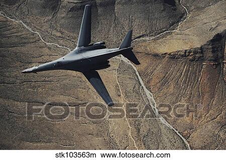 A B-1B Lancer maneuvers over New Mexico during a training mission. View Large Photo Image Picture - A B-1B Lancer maneuvers over New Mexico during a training mission.. Fotosearch