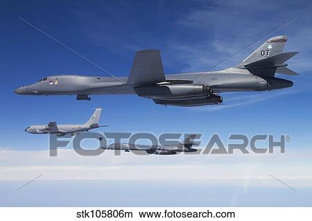 A B-1B Lancer stands by as another Lancer connects with a KC-135 Stratotanker. View Large Photo Image Picture - A B-1B Lancer stands by as another Lancer connects with a KC-135 Stratotanker.. Fotosearch