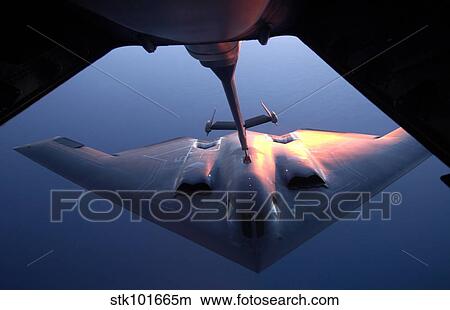 A B-2 Spirit bomber conducts a refueling with a KC-10 Extender. View Large Photo Image Picture - A B-2 Spirit bomber conducts a refueling with a KC-10 Extender.. Fotosearch