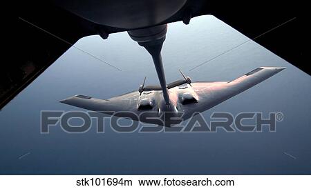 A B-2 Spirit bomber conducts a refueling with a KC-10 Extender. View Large Photo Image Picture - A B-2 Spirit bomber conducts a refueling with a KC-10 Extender.. Fotosearch