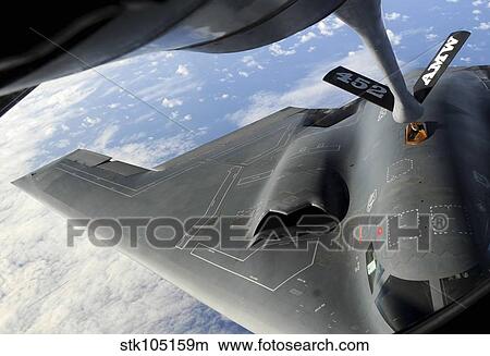A B-2 Spirit receives fuel from a KC-135 Stratotanker. View Large Photo Image Picture - A B-2 Spirit receives fuel from a KC-135 Stratotanker.. Fotosearch