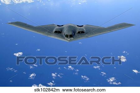 A B-2 Spirit soars through the sky after a refueling mission. View Large Photo Image Picture - A B-2 Spirit soars through the sky after a refueling mission.. Fotosearch