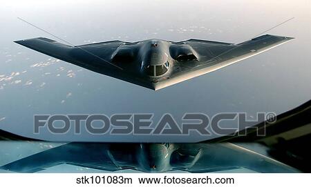 A B-2 Spirit takes on fuel from a KC-135 Stratotanker. View Large Photo Image Picture - A B-2 Spirit takes on fuel from a KC-135 Stratotanker.. Fotosearch