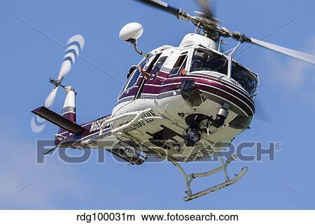 A Bell 412 helicopter flies along the Chicago lakefront. View Large Photo Image Picture - A Bell 412 helicopter flies along the Chicago lakefront.. Fotosearch