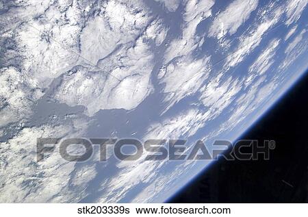 A blue and white part of Earth and the blackness of space viewed from the Earth-orbiting space shuttle Atlantis. View Large Photo Image Stock Photograph - A blue and white part of Earth and the blackness of space viewed from the Earth-orbiting space shuttle Atlantis.. Fotosearch