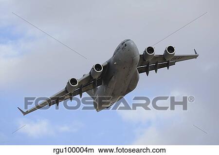 A Boeing C-17 Globemaster III taking off from Nellis Air Force Base. View Large Photo Image Picture - A Boeing C-17 Globemaster III taking off from Nellis Air Force Base.. Fotosearch