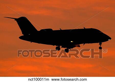 Picture - A Bombardier Challenger CL-600 private jet in flight over Italy.. Fotosearch
