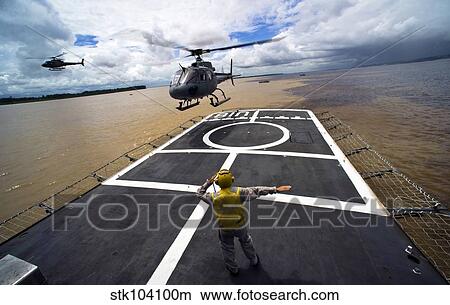 A Brazilian Eurocopter prepares to land aboard a Brazilian navy hospital ship. View Large Photo Image Picture - A Brazilian Eurocopter prepares to land aboard a Brazilian navy hospital ship.. Fotosearch