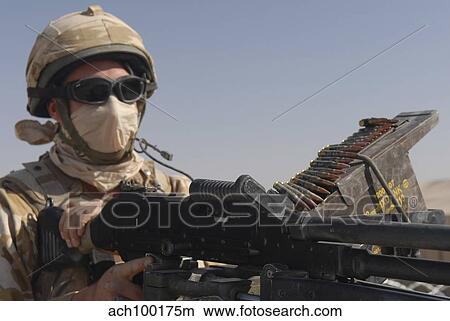 A British Army soldier mans a machine gun mounted on top of a land rover. View Large Photo Image Picture - A British Army soldier mans a machine gun mounted on top of a land rover.. Fotosearch